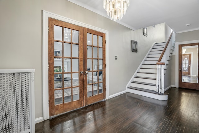 entryway featuring french doors, dark hardwood / wood-style flooring, and a chandelier