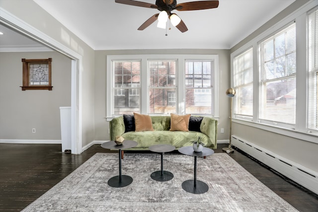 sunroom with a baseboard radiator and ceiling fan