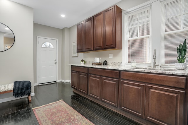 kitchen featuring dark hardwood / wood-style flooring, sink, and dark brown cabinets