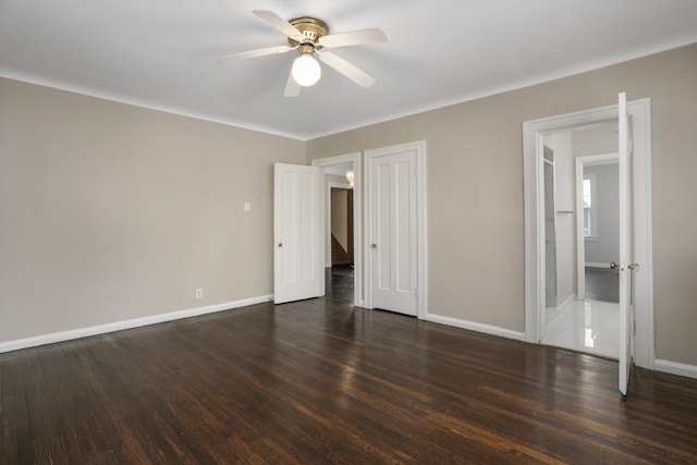 unfurnished bedroom featuring ceiling fan and dark hardwood / wood-style flooring