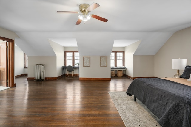 bedroom featuring multiple windows, dark wood-type flooring, and lofted ceiling