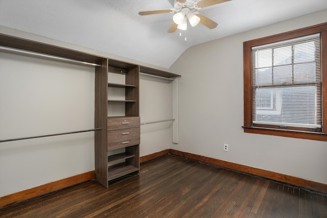 walk in closet featuring dark hardwood / wood-style flooring, vaulted ceiling, and ceiling fan