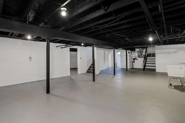 basement with sink and brick wall