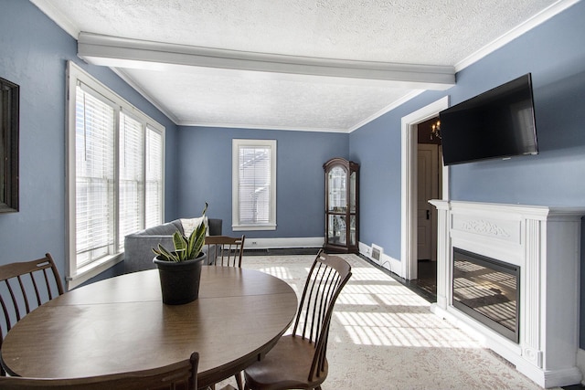 dining area with crown molding and a textured ceiling