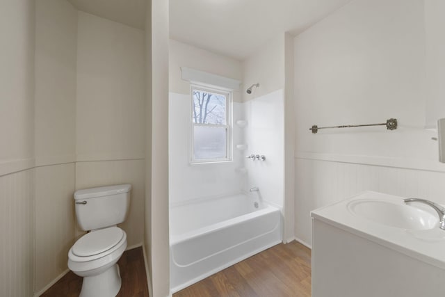 full bathroom featuring vanity, hardwood / wood-style flooring, bathing tub / shower combination, and toilet