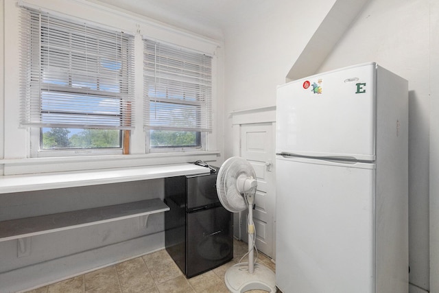 interior space with fridge, white fridge, and a wealth of natural light