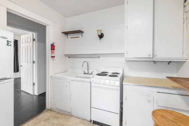 kitchen featuring white cabinetry, sink, and white appliances