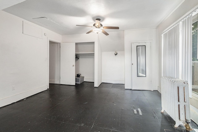 unfurnished bedroom with ceiling fan and radiator heating unit