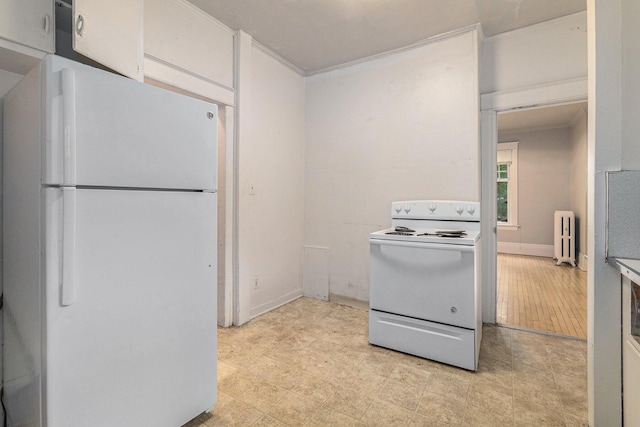 kitchen featuring crown molding, white appliances, and radiator heating unit