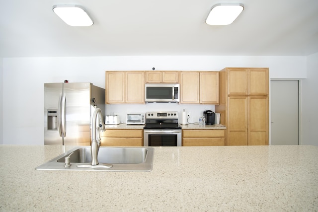 kitchen featuring sink, light brown cabinets, and appliances with stainless steel finishes