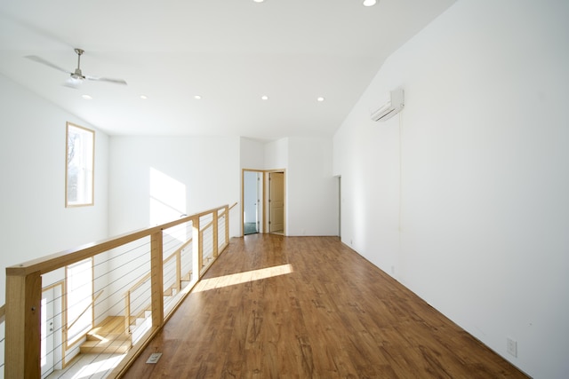 hallway featuring hardwood / wood-style floors and a wall mounted air conditioner