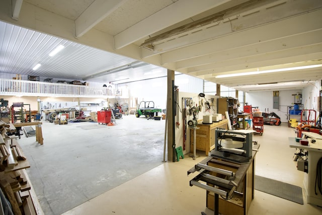 garage featuring electric panel and a workshop area