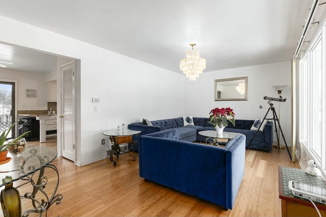 living room with hardwood / wood-style floors and a notable chandelier