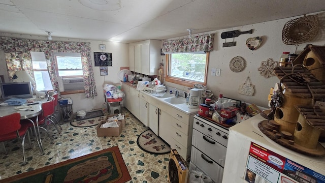 kitchen featuring white cabinetry and cooling unit