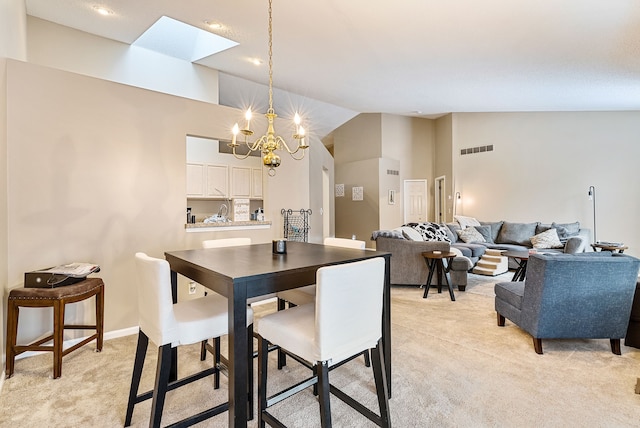 carpeted dining space featuring high vaulted ceiling and a chandelier