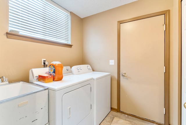 washroom with sink and washer and clothes dryer