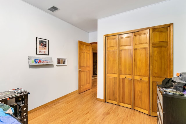 bedroom featuring a closet and light hardwood / wood-style flooring