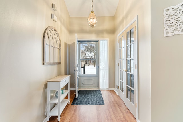 foyer featuring an inviting chandelier and light hardwood / wood-style floors