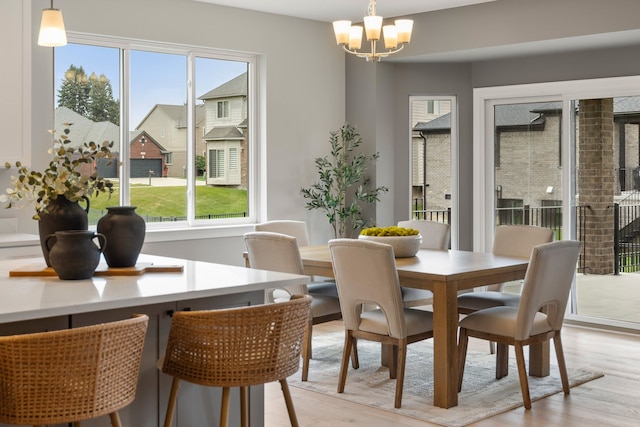 dining room with a chandelier and light hardwood / wood-style floors