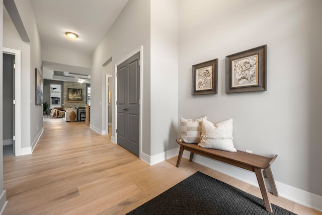 corridor with light hardwood / wood-style flooring