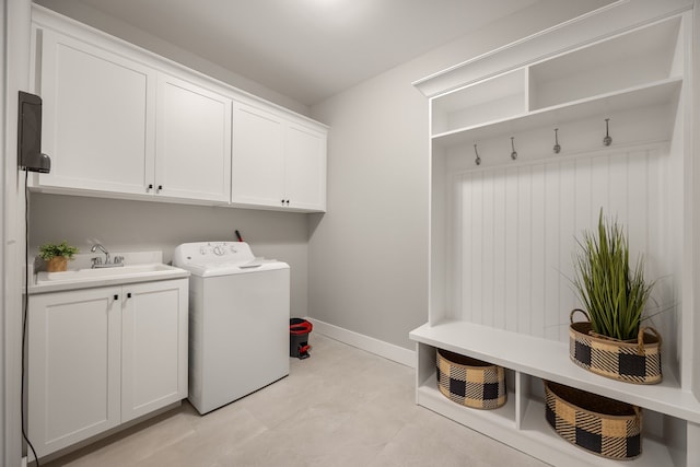 washroom featuring washer / clothes dryer, sink, and cabinets