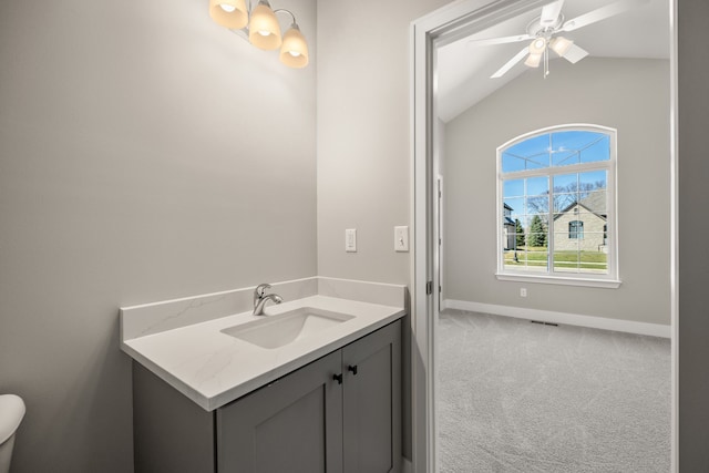 bathroom featuring vanity, vaulted ceiling, and ceiling fan