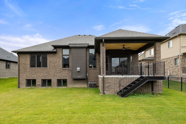 rear view of property with a yard and ceiling fan