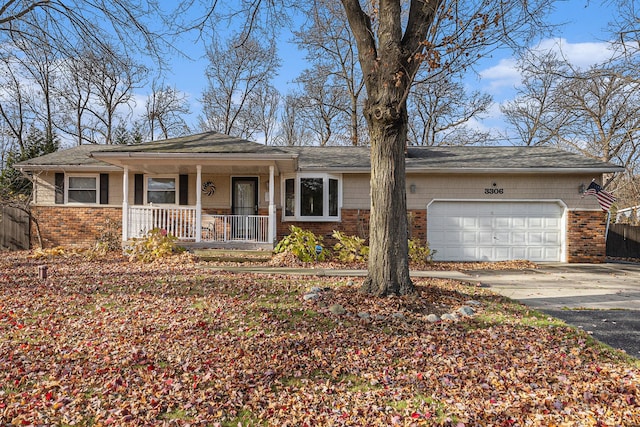 single story home featuring a garage and a porch