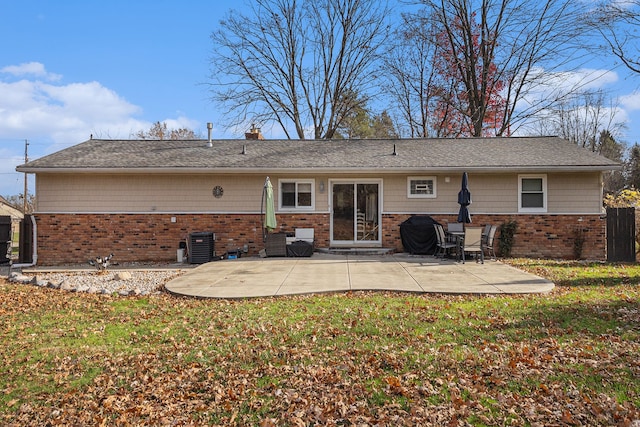 rear view of property featuring a yard and a patio