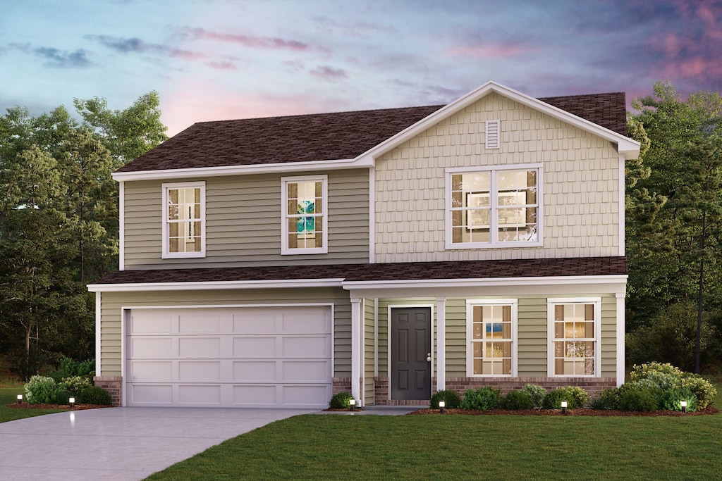 view of front facade featuring a garage and a lawn