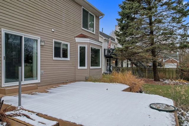 view of snowy exterior featuring a wooden deck