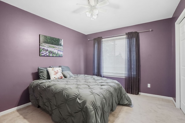 bedroom with ceiling fan and light colored carpet