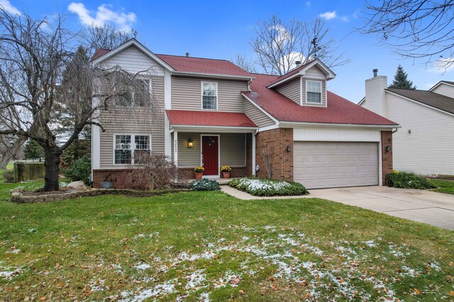 view of front of property with a garage and a front yard