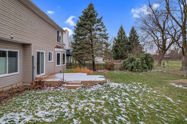 yard layered in snow with a wooden deck