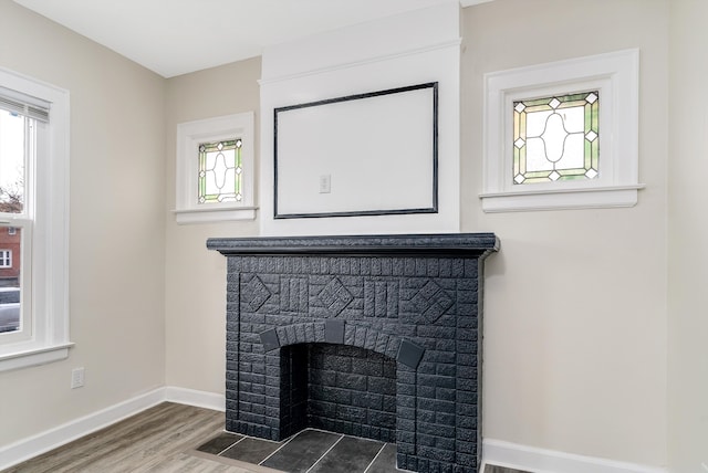 details featuring a brick fireplace and hardwood / wood-style flooring