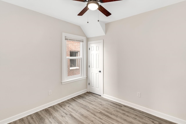 unfurnished room featuring ceiling fan, lofted ceiling, and light hardwood / wood-style flooring