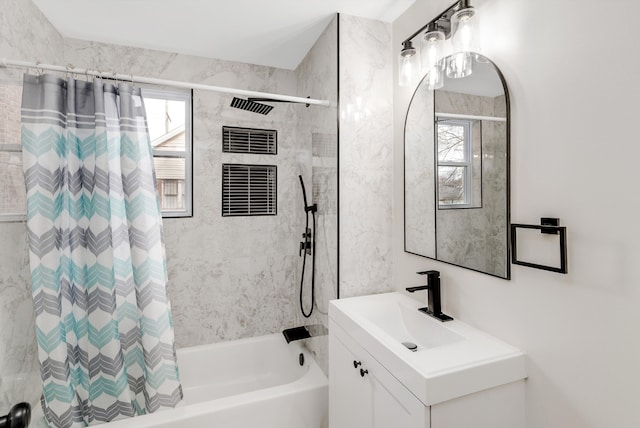 bathroom featuring vanity and shower / bathtub combination with curtain