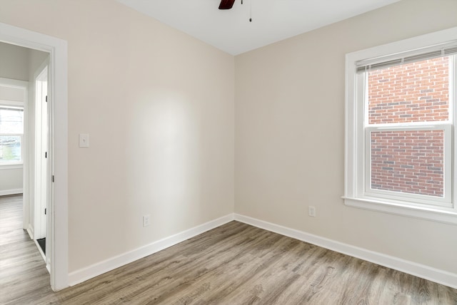 unfurnished room with ceiling fan and light wood-type flooring