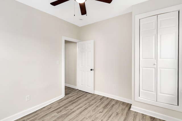 unfurnished bedroom with ceiling fan, a closet, and light hardwood / wood-style flooring