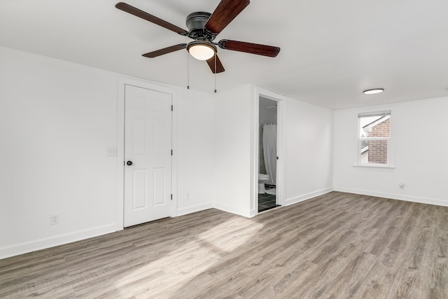 unfurnished room with ceiling fan and light wood-type flooring