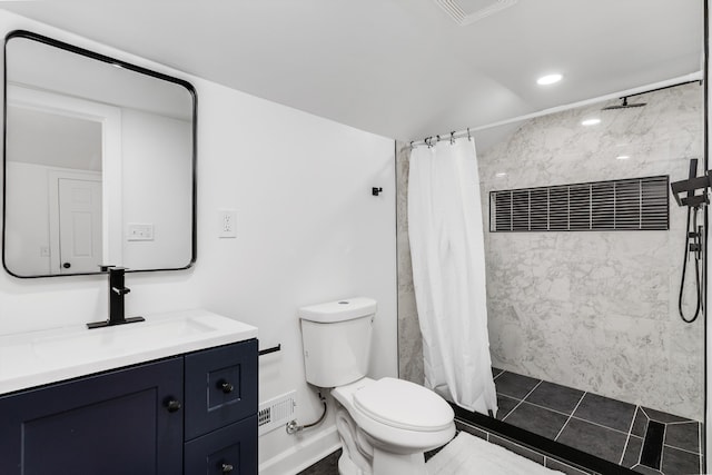 bathroom with walk in shower, vanity, and toilet