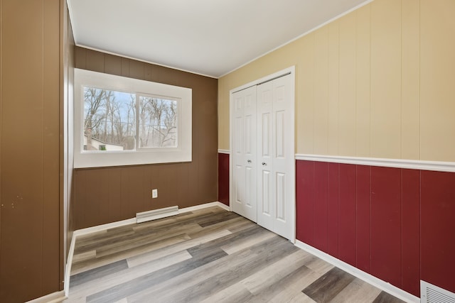 unfurnished bedroom featuring a closet and light wood-type flooring