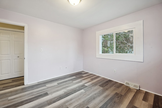 empty room with wood-type flooring