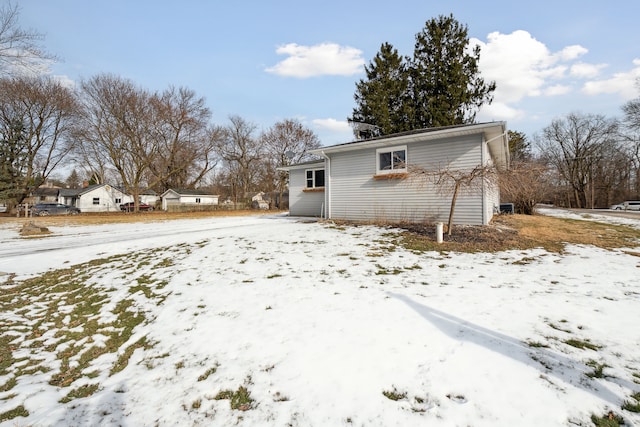 view of snow covered rear of property