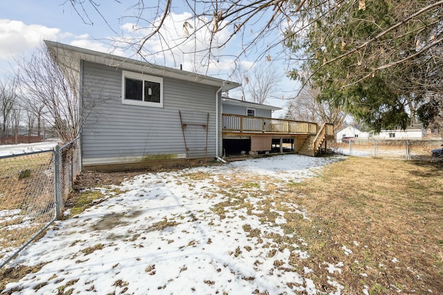 snow covered property with a deck