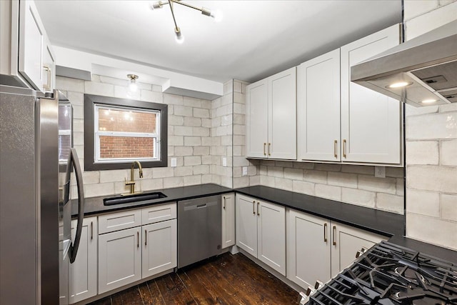 kitchen featuring stainless steel appliances, white cabinetry, sink, and ventilation hood