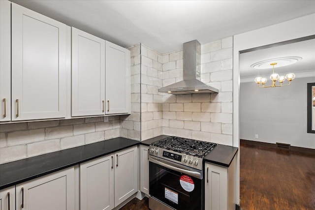 kitchen with wall chimney range hood, white cabinetry, dark hardwood / wood-style floors, gas stove, and decorative backsplash