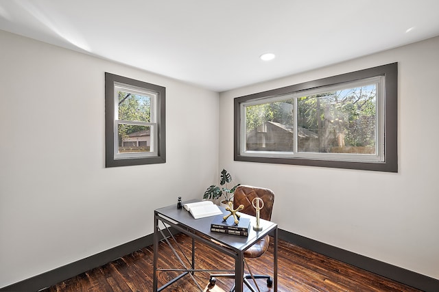 home office featuring dark wood-type flooring and a healthy amount of sunlight