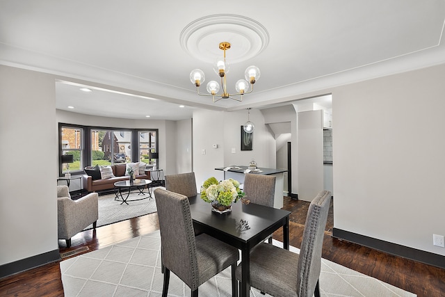 dining space with hardwood / wood-style floors and a chandelier