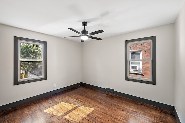 unfurnished room featuring dark wood-type flooring and ceiling fan